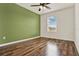 Bedroom with hardwood floors and a brightly painted accent wall at 16521 Prairie School Dr, Winter Garden, FL 34787