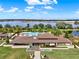 Beautiful clubhouse exterior featuring a low-pitched roof and manicured landscaping near the lake at 16521 Prairie School Dr, Winter Garden, FL 34787