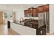 Modern kitchen with a large island, stainless steel appliances, and wood cabinets at 16521 Prairie School Dr, Winter Garden, FL 34787