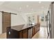 Modern kitchen with a large island, stainless steel appliances, and wood cabinets at 16521 Prairie School Dr, Winter Garden, FL 34787