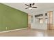 Spacious living room featuring tile floors, a ceiling fan, and large windows for ample sunlight at 16521 Prairie School Dr, Winter Garden, FL 34787