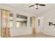 Bright living room with tile floors, recessed lighting, fan, and sunny windows with floral curtains at 16521 Prairie School Dr, Winter Garden, FL 34787