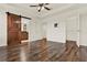 Large main bedroom with hardwood floors, barn door, and tray ceiling at 16521 Prairie School Dr, Winter Garden, FL 34787