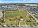 Aerial shot of a park in a beautiful neighborhood with a playground and walking paths at 16521 Prairie School Dr, Winter Garden, FL 34787