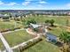 Playground with slides and picnic tables in a community park featuring green lawns and shade canopies at 16521 Prairie School Dr, Winter Garden, FL 34787