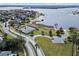 Aerial view showcasing community amenities including a tennis court, boat dock, and lake access at 17438 Promenade Dr, Clermont, FL 34711