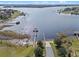 Aerial view capturing lake access with boat dock, ramp, and nearby community amenities at 17438 Promenade Dr, Clermont, FL 34711