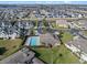 Aerial view featuring community pool, clubhouse, and lush landscaping for a luxurious feel at 17438 Promenade Dr, Clermont, FL 34711