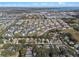 An aerial shot features a townhome community nestled amongst trees, with a scenic lake backdrop at 17438 Promenade Dr, Clermont, FL 34711