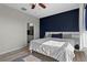 Comfortable bedroom design with modern accents and hardwood flooring with ensuite bathroom access at 17438 Promenade Dr, Clermont, FL 34711