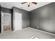 Modern bedroom featuring soft carpet, neutral walls and door to hallway at 17438 Promenade Dr, Clermont, FL 34711