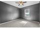 Bedroom featuring soft carpet, ceiling fan, and bright window with shade at 17438 Promenade Dr, Clermont, FL 34711