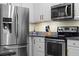 Bright kitchen boasts stainless steel appliances, modern cabinets and granite countertops at 17438 Promenade Dr, Clermont, FL 34711