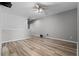 Spacious living room featuring hardwood floors, a ceiling fan and neutral colored walls at 17438 Promenade Dr, Clermont, FL 34711
