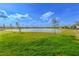 Lake view from backyard with lush green grass at 1756 Chatsworth Cir, St Cloud, FL 34771