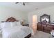 Main bedroom with king-size bed, dresser and ceiling fan at 1756 Chatsworth Cir, St Cloud, FL 34771