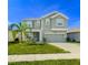 Two-story house with a large driveway and landscaped yard at 1756 Chatsworth Cir, St Cloud, FL 34771