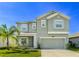 Two-story house with a large driveway and landscaped yard at 1756 Chatsworth Cir, St Cloud, FL 34771
