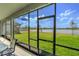 Screened porch overlooking a lake with patio furniture at 1756 Chatsworth Cir, St Cloud, FL 34771