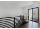 This modern hallway features hardwood floors, metal railings, and sliding glass doors at 1806 Mondrian Cir, Winter Park, FL 32789