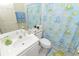 Small bathroom featuring a pedestal sink, standard toilet, and a shower with a playful frog-themed curtain at 1809 Wedgewood Way, Kissimmee, FL 34746