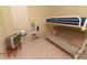 Simple bedroom with a bunk bed, a vintage television, and neutral walls and carpet at 1809 Wedgewood Way, Kissimmee, FL 34746