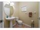 Cozy half bathroom featuring pedestal sink and neutral tones at 2011 Stockton Dr, Sanford, FL 32771