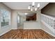 Bright dining area featuring wood-look floors and view into kitchen with cherry cabinets at 2011 Stockton Dr, Sanford, FL 32771