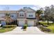 Inviting townhome featuring a two-car garage, neutral colors, and manicured landscaping at 2011 Stockton Dr, Sanford, FL 32771