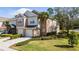 Charming townhome with a well-manicured lawn, lush shrubbery, and attached two-car garage at 2011 Stockton Dr, Sanford, FL 32771