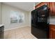 Bright eat-in kitchen features neutral tile flooring and view to the outside at 2011 Stockton Dr, Sanford, FL 32771