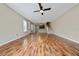 Open concept living room with wood-look floors, ceiling fan, and natural light at 2011 Stockton Dr, Sanford, FL 32771