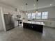 Modern kitchen with white shaker cabinets, large island, and stainless steel appliances at 2118 Whitney Marsh Aly, Orlando, FL 32804