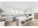 Modern kitchen featuring a large island, stainless steel appliances, and sleek white cabinetry at 2221 Valentine Aly, Orlando, FL 32804