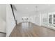 Open concept living room with hardwood floors, large windows and modern chandelier at 2221 Valentine Aly, Orlando, FL 32804