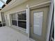 Beige door, white trim and a small window with blinds offer privacy at 2351 Fenton Ave, Clermont, FL 34711