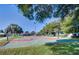 Outdoor basketball court surrounded by green grass and mature trees at 2351 Fenton Ave, Clermont, FL 34711