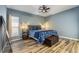 Bedroom with a large window, modern ceiling fan, and stylish tile floors at 2351 Fenton Ave, Clermont, FL 34711