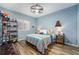 Bedroom featuring a queen bed, modern ceiling fan, and stylish tile floors at 2351 Fenton Ave, Clermont, FL 34711