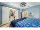 Bedroom with an open closet with drawers, open bathroom access, modern ceiling fan, and stylish tile floors at 2351 Fenton Ave, Clermont, FL 34711