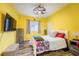 This sun-filled bedroom features hardwood floors and a queen-size bed with decorative pillows at 2351 Fenton Ave, Clermont, FL 34711