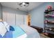 Bedroom featuring a queen bed, modern ceiling fan, and stylish tile floors at 2351 Fenton Ave, Clermont, FL 34711