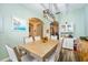 Stylish dining room showcasing modern lighting, wood-look floors, and seamless transition to kitchen area at 2351 Fenton Ave, Clermont, FL 34711