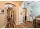 Inviting hallway with warm wood-look floors and elegant archways leading to dining area and living spaces at 2351 Fenton Ave, Clermont, FL 34711