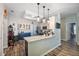 Open concept kitchen with large island, modern pendant lights, and stylish two-tone cabinetry at 2351 Fenton Ave, Clermont, FL 34711