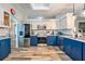 Modern kitchen featuring two-tone cabinets, stainless steel appliances, and beautiful granite countertops at 2351 Fenton Ave, Clermont, FL 34711