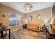 Cozy living room featuring ample natural light, warm paint colors, and wood-look flooring at 2351 Fenton Ave, Clermont, FL 34711