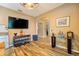 Cozy living room with a large flat-screen TV and stylish console table under a decorative ceiling fan at 2351 Fenton Ave, Clermont, FL 34711