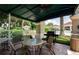 Outdoor seating with a grill in a shaded area perfect for entertaining at 2351 Fenton Ave, Clermont, FL 34711