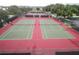 Aerial view of community tennis courts with net and landscaping at 2351 Fenton Ave, Clermont, FL 34711